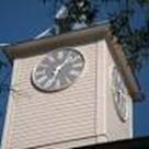 A clock tower with a large clock on it
Description automatically generated